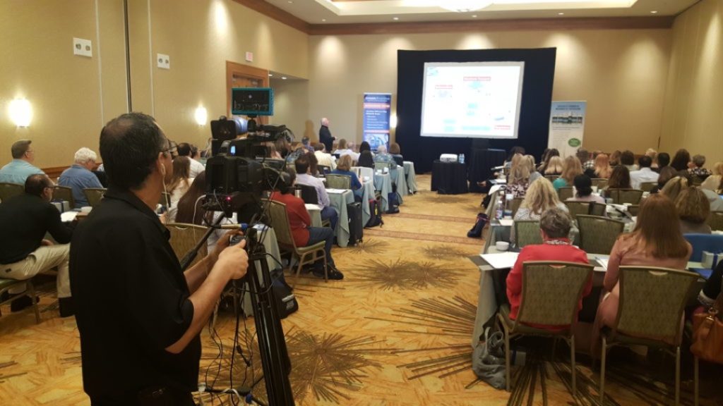 Man shooting Video at a Conference Meting