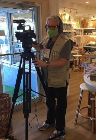 Man shooting video with camera on tripod